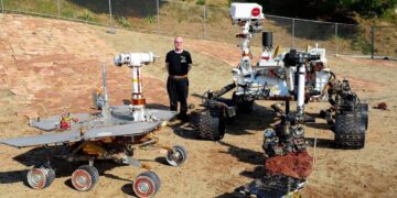 Paolo Bellutta con a sinistra il modello di MER (il rover gemello Spirit e Opportunity) e a destra, Curiosity. In basso il primo rover marziano, il Sojourner. Credits: Paolo Bellutta.