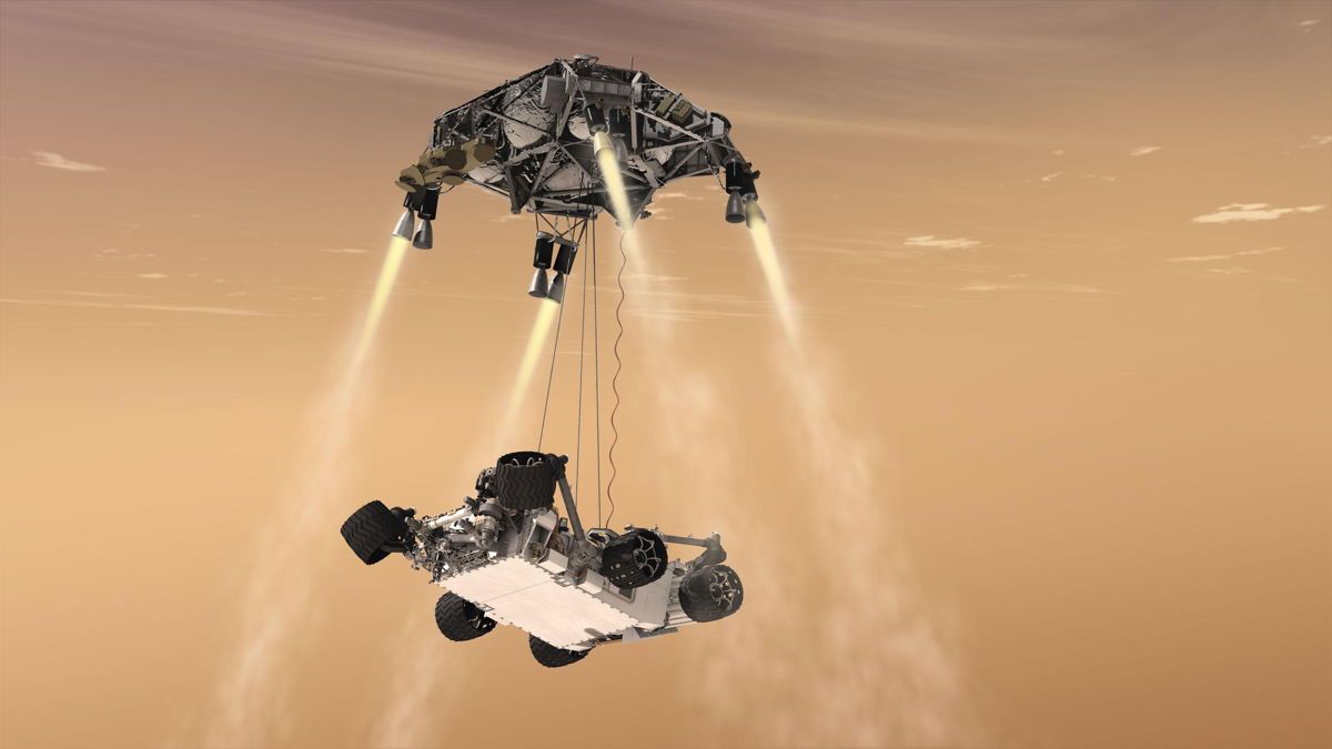 Rappresentazione artistica dello SkyCrane e del rover Perseverance con le ruote ancora ripiegate. Credits: NASA